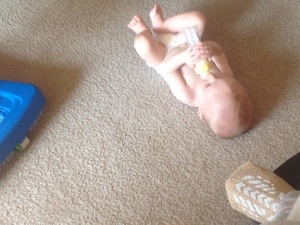 The little guy, on the floor, drinks a bottle of breast milk while I watch from my wheelchair.