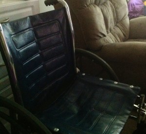 My wheelchair, blue leather, black and gray wheels, foot rests and handles.