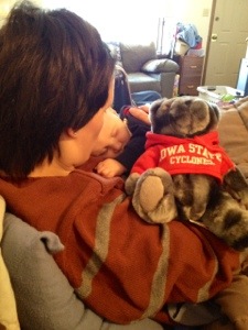 The Little Guy sleeping on my chest during the first quarter of the Iowa State vs. Iowa game, with our Iowa State bear.