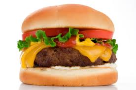 A cheesburger - bun, tomato, lettuce, ketchup, cheese, burger, bun