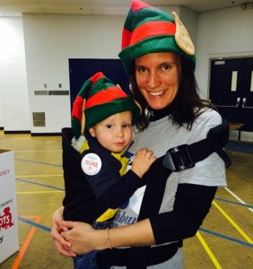 Michaela and the Little Guy in elf hats during a Toys for Tots donation day. 